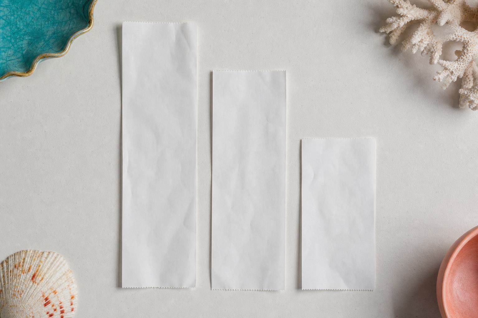 Three paper receipts of different lengths laid out side by side on a pale surface
